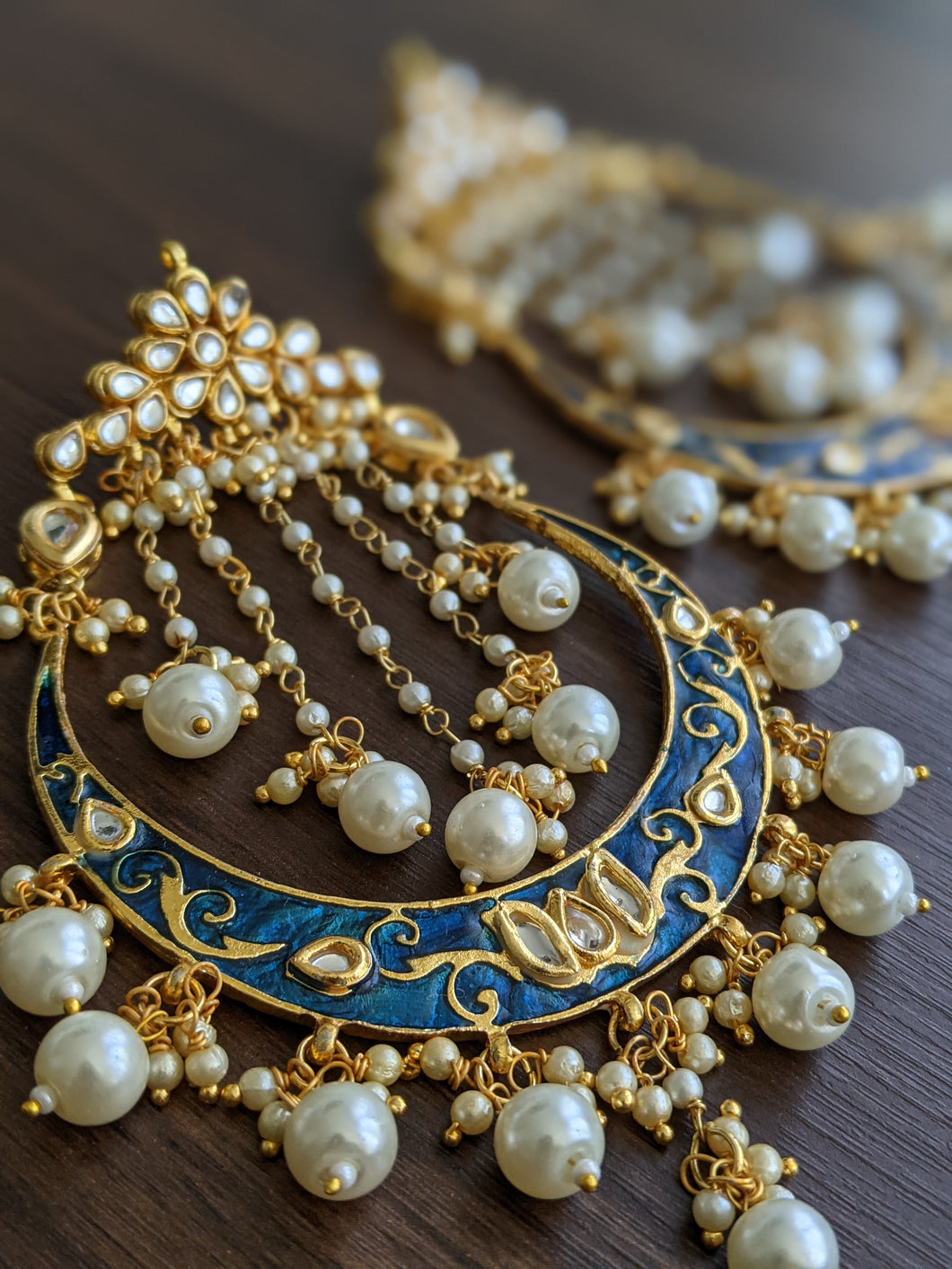 These earrings are a perfect example of royalty & exquisite craftsmanship. These royal blue earrings have a crescent moon shaped design which is hand painted & crafted by skilled artisans.