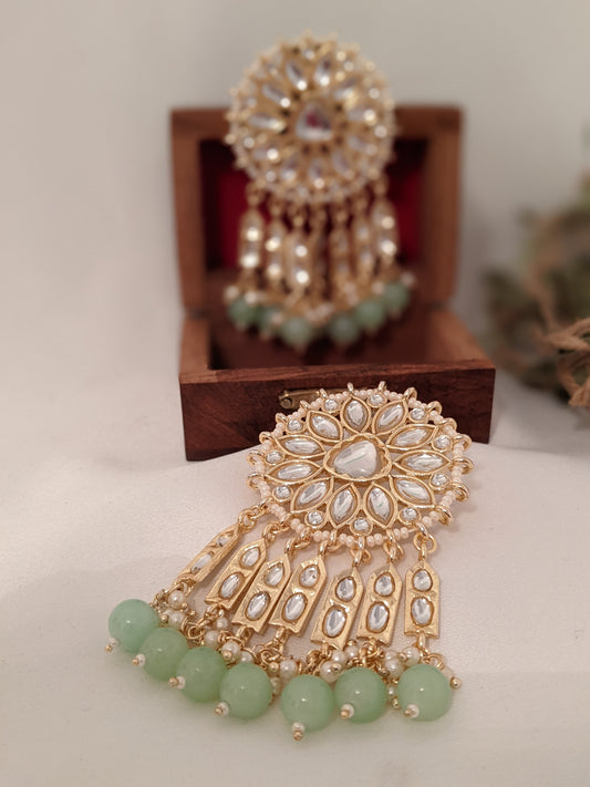 These beautiful earrings speak for themselves. Meticulously handcrafted in Kundan with dangling green pearl drops.