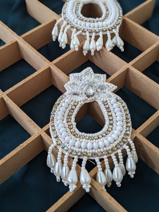Bohemian fabric earrings in white & golden, these feather weight earrings are perfect for a quirky look when you wana give rest to your ears but still make a statement.   And by feather weight we mean the material used is fabric, so they are literally feather weight